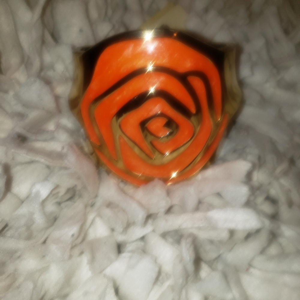Gold bracelet with an orange floral design